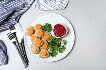 Flat lay composition with plate of traditional Passover (Pesach) gefilte fish  on light background. Space for text
