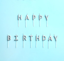 Flat lay composition with birthday candles on color background