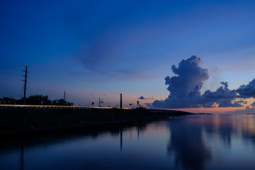 Fototapeta na wymiar Coastal Highway 1 traffic as sunset falls on the overseas highway and the Florida Keys