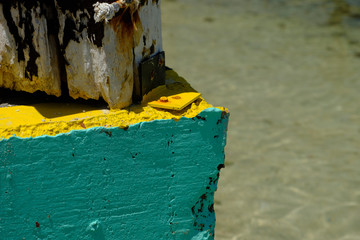 Colorfully painted concrete and wood at the edge of a dock in the Florida Keys