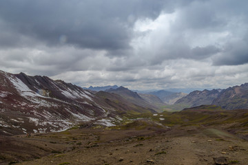 View of the incredible rainbow mountains outside of Cusco, Peru. The quantities are a variety of colors of mineral deposits in the soil