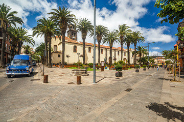 A vintage car passes by Square with fountain near the church of the Immaculate Conception in La Laguna town on Tenerife island © Yury