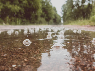 Bubbles in a puddle on the road in the rain. Autumn sadness concept