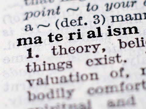 Dictionary definition of word materialism. Selective focus.