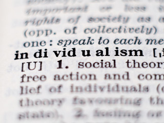 Dictionary definition of word individualism. Selective focus.