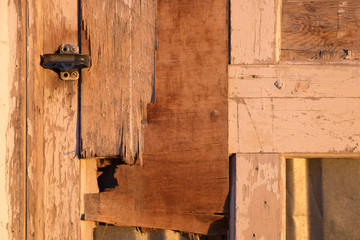 Old weathered wood door with latch.