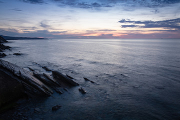 scenic view with sunset on atlantic ocean with rocks in socoa, basque country, france