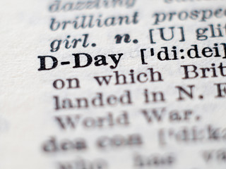 Dictionary definition of word D-Day. Selective focus.
