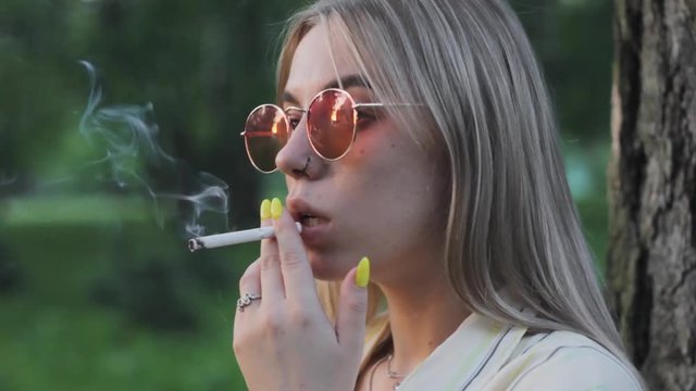 girl smokes  cigarette  portrait attractive