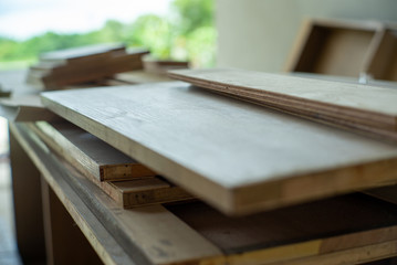 Selective focus on pile of wooden boards for installing the interior work at the construction site