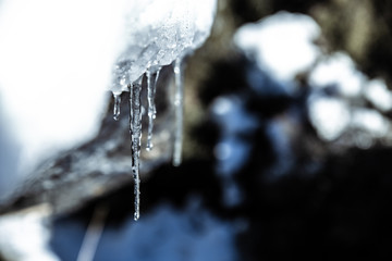 Icicles, frozen water icicles close up winter nature background, cold weather snowy season
