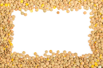 Raw, dry, uncooked brown lentil legumes frame border texture background flat lay top view from above