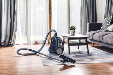 Vacuum cleaner in living room at home