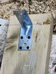 reinforced steel corner fixed to the board with screws