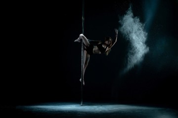 Girl in dust cloud on pylon dancing in the dark