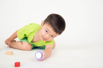 Little Asian toddler boy playing wood blocks wear helmet engineer