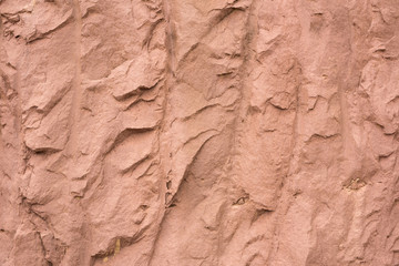 Reddish brown hard soil cracks stripes irregular texture background closeup