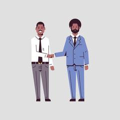 couple businessmen handshaking business partners hand shake during meeting agreement partnership concept african american male colleagues in formal wear standing together flat full length