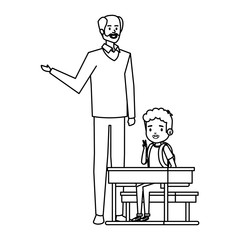 student boy seated in school desk with male teacher