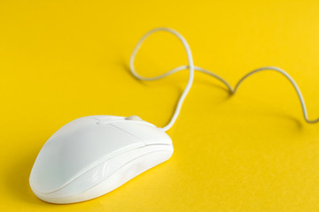 white computer mouse isolated on yellow background selective focus