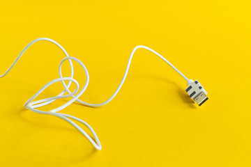 white USB Micro cable isolated on yellow background