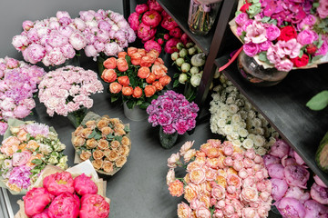 Vases with different colored flowers, showcase flower shop. Beautiful spring bouquets. . Small family business. Work florist. copy space