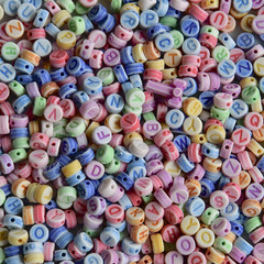 Pastel coloured alphabet beads.