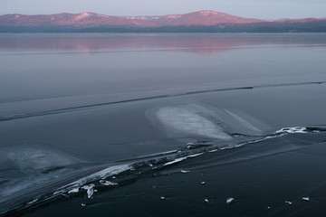 Ice texture on the surface of a large lake in the highlands. High resolution and detail.