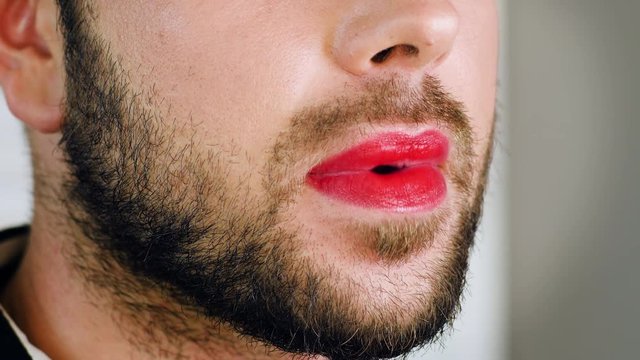 Portrait of metrosexual or gay man with red lips