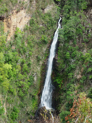 Fototapeta na wymiar A Beautiful Mae Surin Waterfall, The Tallest Waterfall in A National Park of Mae Hong Son Province, Northern Thailand for Background, Backdrop, or Wallpaper.