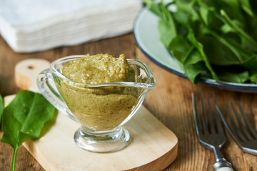 Sorrel sauce on wooden background