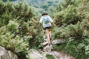 Naklejka premium Young lady tourist hiking in the mountains of Georgia