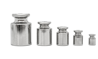 Row of weights for laboratory scales on white.