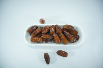 stack of dates in a white container top view isolated on white background