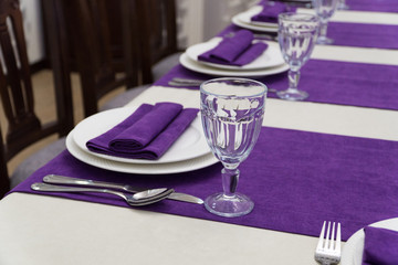 serving banquet table in a luxurious restaurant in purple and white style