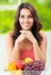 Portrait picture of smiling beautiful woman with plate of fruits