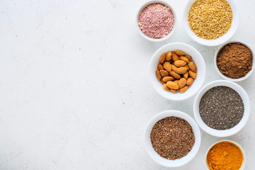 Obraz na płótnie Canvas Healthy super food clean eating selection (seeds, powder turmeric, carob, nuts, dried beet)