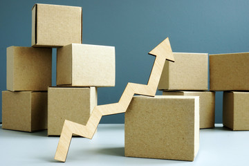 Increase sales concept. Cardboard boxes and arrow.