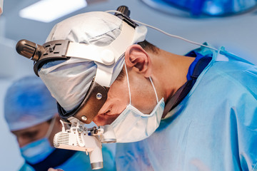 Group of surgeons in operating room with surgery equipment. Modern Hospital