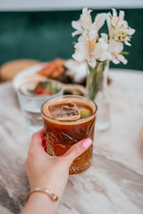 Summer breakfast with espresso tonic, refreshing summer drink with coffee, tonic water and lemon.