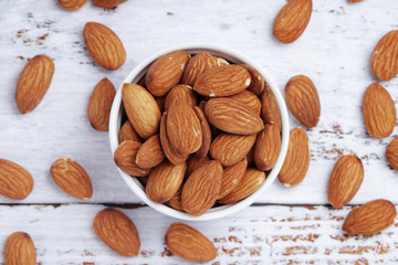 A small bowl with almond at white background