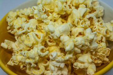 Popcorn is a snack made from corn kernels it is white color popular for people in many countries.
