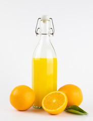 Fresh healthy orange juice in a glass bottle on white background. summer concept.