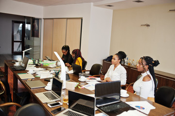 African american women colleagues, crew of divercity female partners in office sit at the table.