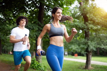 Fototapeta premium Happy couple running and jogging together outdoor