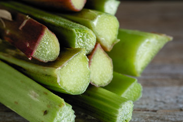 Bunch of rhubarb on wooden background