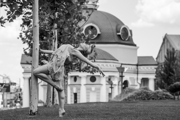 Ballerina in city. Ballet dancer dancing outdoor. Concept of freedom and sport body 