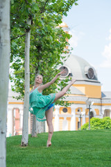 Fototapeta premium Ballerina in city. Ballet dancer dancing outdoor. Concept of freedom and sport body 