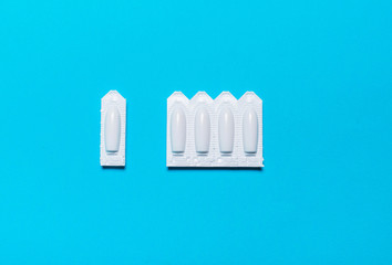 Suppository for rectal,vaginal use on blue background