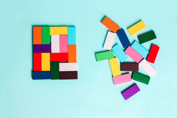 order and chaos. Chaotic unorganized colored dominoes and ordered. Concept of business model,...